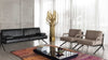 Schwarzes Ledersofa von Desede Switzerland neben beigen Ledersesseln, modernes Design.