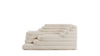 Ein terrassenförmiges Elementsofa aus beige-weißem Stoff von Desede Switzerland.