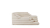 Ein terrassenförmiges Stoffsofa in Beige von Desede Switzerland mit grafischem Muster.