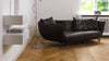 Schwarzes Ledersofa von Desede Switzerland mit geschwungenem Design auf Holzfußboden.