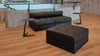 Schwarzes Ledersofa von Desede Switzerland mit passendem Hocker und zwei Beistelltischen.