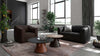 Schwarzes Ledersofa und brauner Sessel von Desede Switzerland in modernem Wohnzimmerambiente.