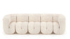 Ein geschwungenes, beige Stoffsofa von Desede Switzerland mit eleganter Musterung.